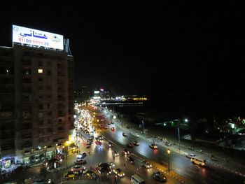 Vehicles on road in city at night