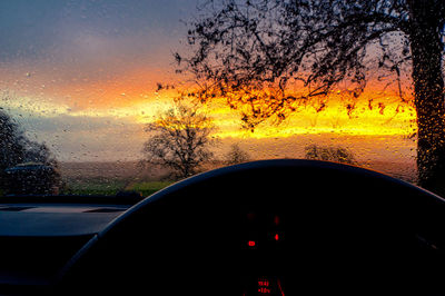 Scenic view of sunset seen through car windshield