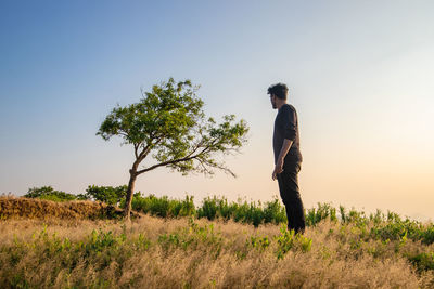 Man standing on field against sky