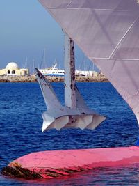 Sailboats in sea against blue sky