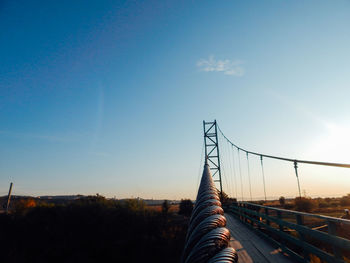 Bridge against clear blue sky during sunset