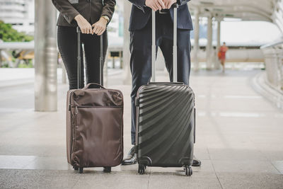 Low section of people with suitcases at airport