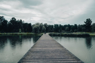 Pier over lake against sky