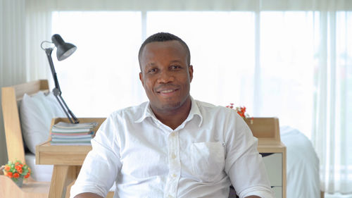 Portrait of smiling man sitting at home