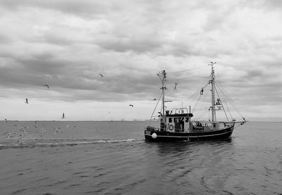 Boats in sea against sky