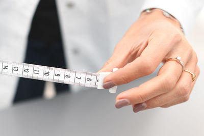 Close-up of hand holding thermometer