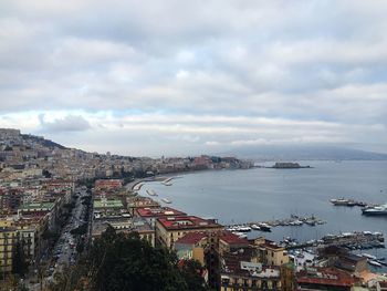 View of cityscape against cloudy sky