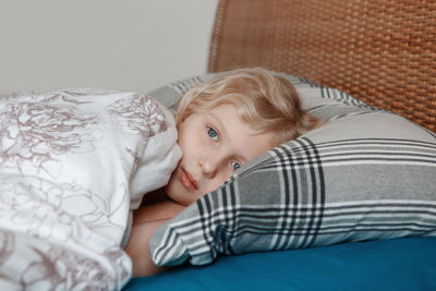 Portrait of boy lying on bed