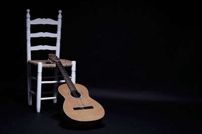 Close-up of guitar against black background