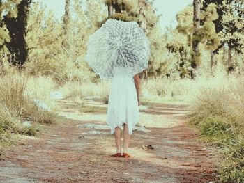 Full length of woman walking on road