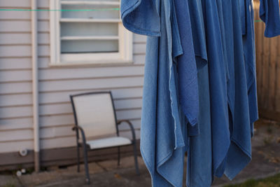 Close-up of person standing against window of building