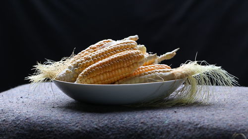 Close-up of corn cubs in bowl on table