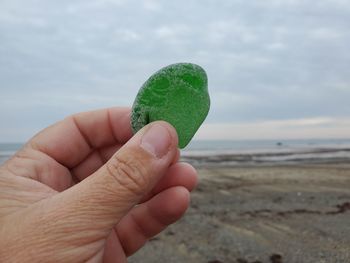 Close-up of hand holding sea glass