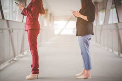 Side view of women walking in corridor