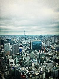 Cityscape against cloudy sky