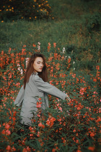 Portrait of woman standing on field