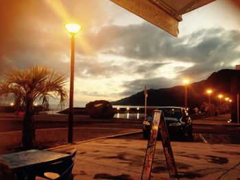 Street light against cloudy sky