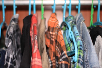 Close-up of clothes hanging on rack at market