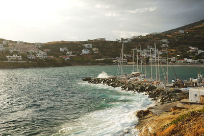 Scenic view of sea by buildings against sky