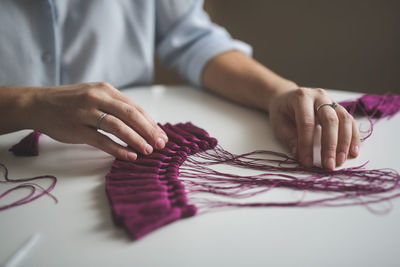 Craftswoman makes brushes from threads. concept creativity and handmade, toning in real interior