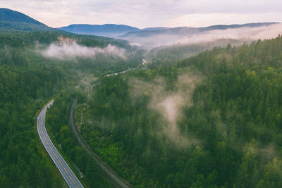 High angle view of road by mountains against sky