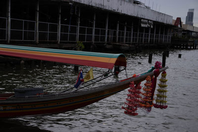 Boats in river with buildings in background