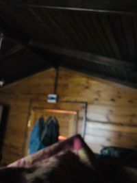 Low section of woman relaxing on bed