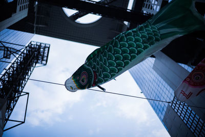 Low angle view of bird perching on building
