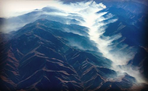 Aerial view of mountains in foggy weather