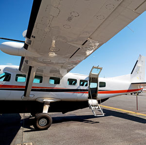 Airplane on airport runway against sky