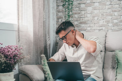 Young man using laptop at home