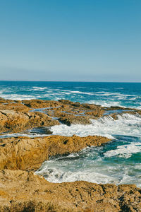 Pacific ocean waves breaking against bluffs in baja, mexico.