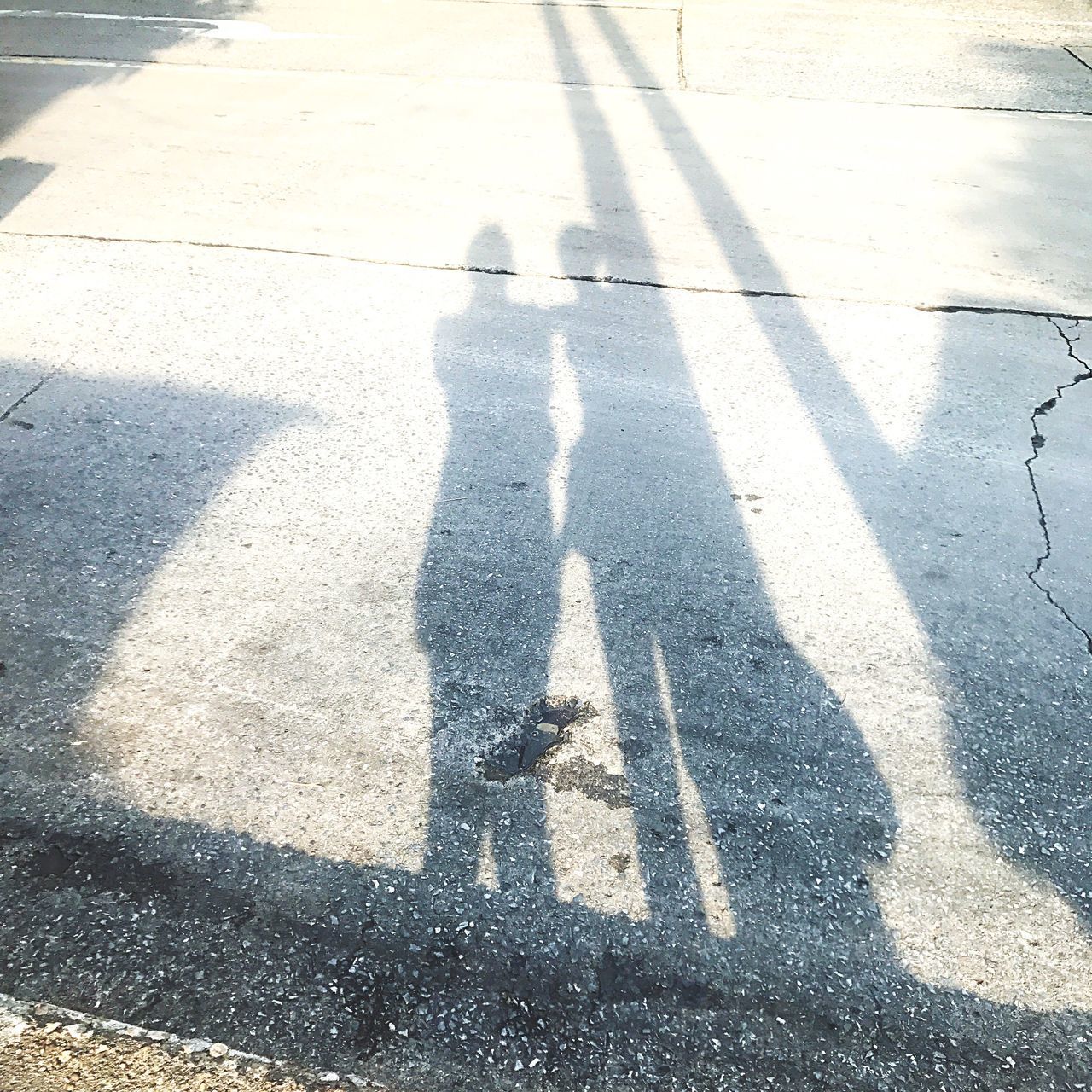 SHADOW OF PEOPLE ON ROAD