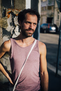 Man looking away while standing in city