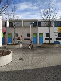 Bicycle by building against sky