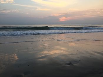 Scenic view of beach against sky during sunset