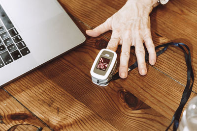 High angle view of woman using laptop on table