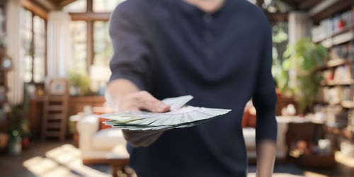 Midsection of man reading book