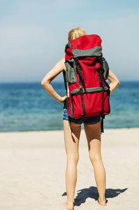 Rear view of woman walking on beach