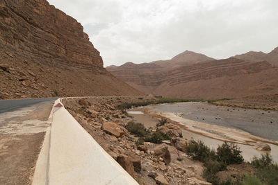 Road by mountain against sky