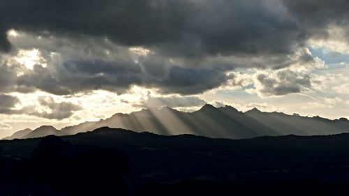 Scenic view of mountains against cloudy sky