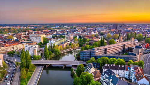 High angle view of road by buildings against sky during sunset