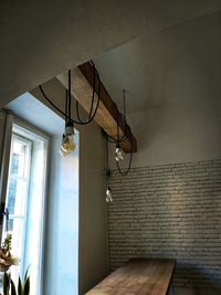 Low angle view of illuminated light hanging on wall
