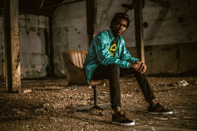 Portrait of young man sitting on chair