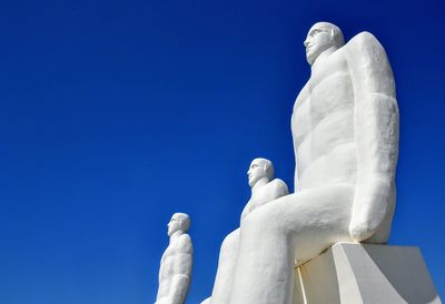 Low angle view of statue against blue sky