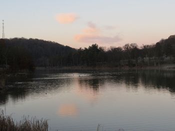 Scenic view of lake against sky at sunset