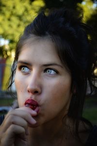 Close-up of woman eating lollipop