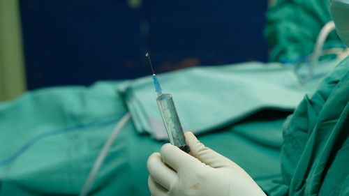 Cropped image of doctor holding syringe