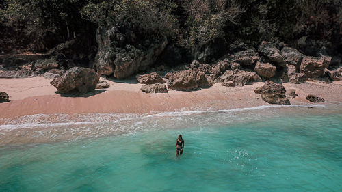 Aerial view of woman standing in sea