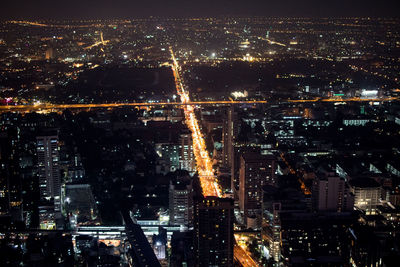 High angle view of illuminated city buildings at night